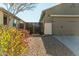 Side view of a home with a gate and two-car garage at 2185 E Hazeltine Way, Gilbert, AZ 85298