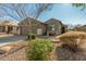 Single-story home with a two-car garage and landscaped yard at 2185 E Hazeltine Way, Gilbert, AZ 85298