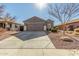 Single-story home with a two-car garage and desert landscaping at 2185 E Hazeltine Way, Gilbert, AZ 85298