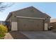 Two-car garage and front entry of a single story home at 2185 E Hazeltine Way, Gilbert, AZ 85298