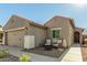 Single-story home with a two-car garage and seating area at 2185 E Hazeltine Way, Gilbert, AZ 85298