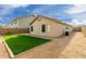 Artificial turf and a covered patio are featured in this home's backyard at 2298 E Hazeltine Way, Chandler, AZ 85249