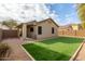 Home features a backyard with artificial turf and a covered patio at 2298 E Hazeltine Way, Chandler, AZ 85249