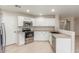 Bright kitchen featuring stainless steel appliances and white cabinets at 2298 E Hazeltine Way, Chandler, AZ 85249