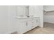 Bright bathroom features a double sink vanity, wood look tile floor, and a walk in closet at 2324 W Moody Trl, Phoenix, AZ 85041
