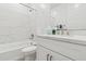 Bright bathroom featuring a white vanity with a marble backsplash and a bathtub with a shower at 2324 W Moody Trl, Phoenix, AZ 85041