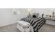 This bedroom offers a striped bed, stylish décor, and a trunk for extra storage at 2324 W Moody Trl, Phoenix, AZ 85041