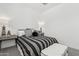 Cozy bedroom showcasing modern decor, a striped bed, and stylish side tables at 2324 W Moody Trl, Phoenix, AZ 85041