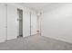 This bright bedroom features a neutral color palette, closet, and a connecting door at 2324 W Moody Trl, Phoenix, AZ 85041