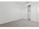 Bright bedroom featuring plush carpeting and a closet with sliding doors at 2324 W Moody Trl, Phoenix, AZ 85041