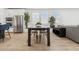 Open dining area with a dark wood table, white chairs, and stainless steel appliances at 2324 W Moody Trl, Phoenix, AZ 85041