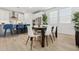 Open dining area with a dark wood table, white chairs, and stainless steel appliances at 2324 W Moody Trl, Phoenix, AZ 85041