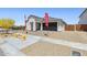 Charming single-story home with a manicured front yard and a two-car garage at 2324 W Moody Trl, Phoenix, AZ 85041