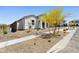 Stylish home with desert landscaping, featuring a front yard with shrubs and trees at 2324 W Moody Trl, Phoenix, AZ 85041