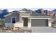 Single-story home with gray exterior, two-car garage, and desert landscaping at 2324 W Moody Trl, Phoenix, AZ 85041