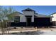 Beautiful single-story home with a two car garage, tidy landscaping, and a covered entryway at 2324 W Moody Trl, Phoenix, AZ 85041
