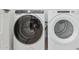Modern laundry room equipped with a white washer and dryer for efficient laundry care at 2324 W Moody Trl, Phoenix, AZ 85041