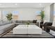 Bright living room featuring a comfortable gray sectional and modern decor at 2324 W Moody Trl, Phoenix, AZ 85041
