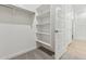 Large walk-in closet with built-in shelving, rod, and carpeted floor at 2324 W Moody Trl, Phoenix, AZ 85041