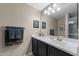 Clean bathroom with dark vanity, large mirror, and ample counter space at 240 W Juniper Ave # 1173, Gilbert, AZ 85233