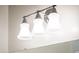 Three-light vanity fixture with frosted glass shades at 24018 N 165Th Dr, Surprise, AZ 85387