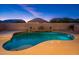 Expansive pool and patio at twilight at 24018 N 165Th Dr, Surprise, AZ 85387