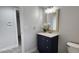 Bathroom with dark vanity, white countertop, and framed mirror at 2463 W Morning Sun Cir, San Tan Valley, AZ 85144