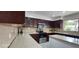 Kitchen with dark wood cabinets and granite countertops at 2463 W Morning Sun Cir, San Tan Valley, AZ 85144