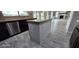 Kitchen island with granite countertop and gray wood-paneled sides at 2463 W Morning Sun Cir, San Tan Valley, AZ 85144