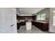 Kitchen with dark wood cabinets, an island, and granite countertops at 2463 W Morning Sun Cir, San Tan Valley, AZ 85144