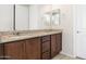 Double vanity bathroom with granite countertop and wood cabinets at 26448 W Kimberly Way, Buckeye, AZ 85396