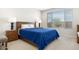 Cozy bedroom with wood bed frame, nightstands, and blue bedding at 26448 W Kimberly Way, Buckeye, AZ 85396