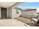 Covered patio with brick flooring and rocking chairs at 26448 W Kimberly Way, Buckeye, AZ 85396