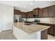 Modern kitchen with stainless steel appliances and granite island at 26448 W Kimberly Way, Buckeye, AZ 85396