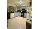 Galley style kitchen with grey cabinets and tiled floors at 2645 W Wolf St, Phoenix, AZ 85017