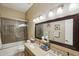 Well-lit bathroom with dual sinks and a bathtub shower combo at 26616 N 42Nd Way, Cave Creek, AZ 85331