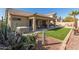 Landscaped backyard featuring a covered patio and hot tub at 2878 N Paisley Ave, Casa Grande, AZ 85122