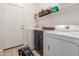 Convenient laundry room with washer, dryer, and storage shelves at 2878 N Paisley Ave, Casa Grande, AZ 85122