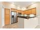 Kitchen with wood cabinets, granite countertops, and stainless steel appliances at 2989 N 44Th St # 2001, Phoenix, AZ 85018