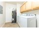 Convenient laundry room with washer, dryer, and cabinets at 2989 N 44Th St # 2001, Phoenix, AZ 85018