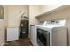 Laundry room with washer, dryer, and extra storage at 2989 N 44Th St # 2015, Phoenix, AZ 85018