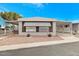 Inviting manufactured home with covered carport and landscaping at 305 S Val Vista Dr # 125, Mesa, AZ 85204