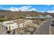 Aerial view of house, showcasing the front yard and mountain views at 34083 N Paseo Grande Dr, Queen Creek, AZ 85144