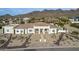 Aerial view of single-story home with landscaped yard and mountain backdrop at 34083 N Paseo Grande Dr, Queen Creek, AZ 85144