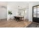 Bright dining room with wood floors and modern light fixture at 34083 N Paseo Grande Dr, Queen Creek, AZ 85144