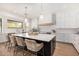 Modern kitchen with white cabinets and large island at 34083 N Paseo Grande Dr, Queen Creek, AZ 85144