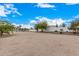 Landscaped side yard with artificial turf and desert plants at 34083 N Paseo Grande Dr, Queen Creek, AZ 85144