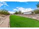 Artificial turf and stone lined pathway in side yard at 34083 N Paseo Grande Dr, Queen Creek, AZ 85144