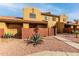 Two-story stucco home with a gated entrance and desert landscaping at 3511 E Baseline Rd # 1203, Phoenix, AZ 85042