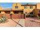 Tan two-story home with a gated entry and walkway at 3511 E Baseline Rd # 1203, Phoenix, AZ 85042